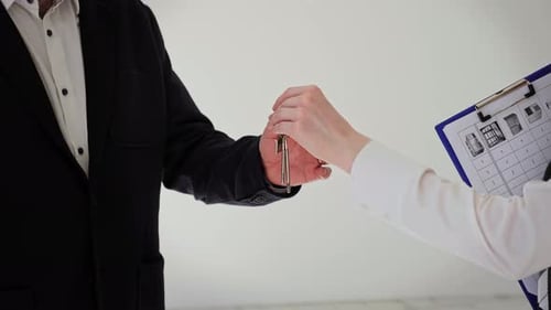 Business People Receiving Keys to Their New Home Building or Cafe for Business