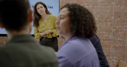 Businesswoman Presenting in Office during Meeting