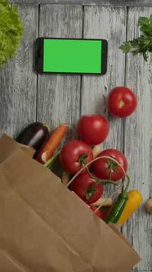 Fresh Vegetables and Cell Phone on Wooden Table