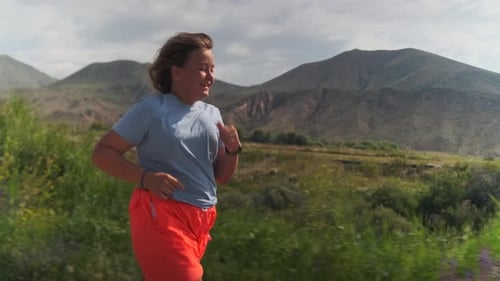 Teen Girl Jogging on Rural Mountain Path