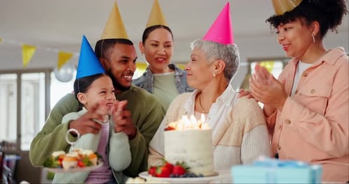 Family Celebrates Birthday Together Around Lit Cake