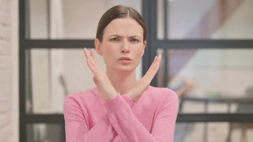 Woman Gesturing 'No' with Crossed Arms
