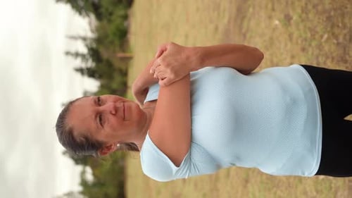 Woman Stretching Her Arms in Rural Setting