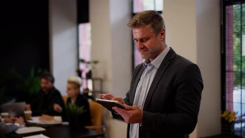 Man Using Tablet in Office Setting