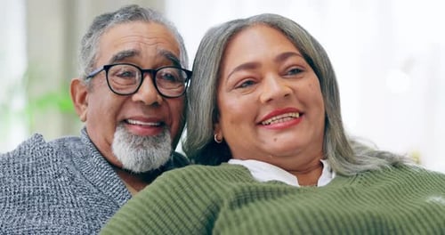 Happy Mature Couple Relaxing Together on Sofa