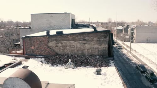 Broken, fallen brick wall on roof. Drone pan left with wall point of view. 4k Mavic 3. UHD. Winter s