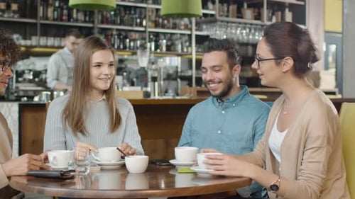 Group of Positive Mixed race Young People Having Conversation in Coffee Shop.