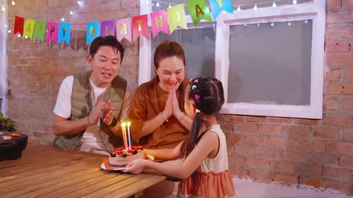 Happy Family Celebrating Birthday with Cake Indoors