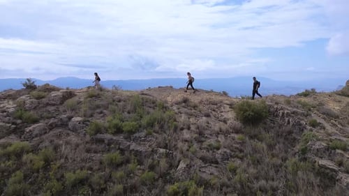 Aerial View of Hikers Trekking Toward a Mountain Summit on a Scenic Outdoor Adventure