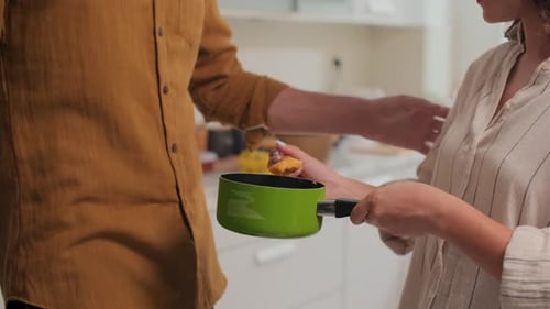 Couple Cooking Together, Tasting Food in Kitchen