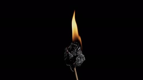 Burning object on stick in dark environment