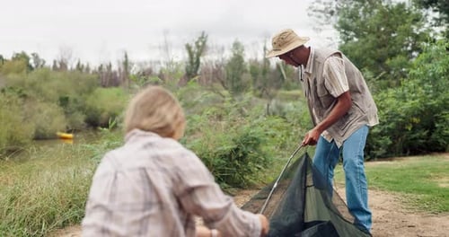 People Setting up Tent While Camping Outdoors