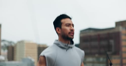 Asian man, fitness and jump rope on rooftop in city for workout, cardio exercise