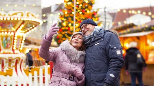 Senior Couple Takes Selfie at Christmas Market