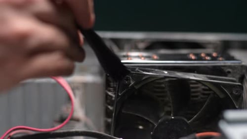 Closeup Unrecognizable Human Hands Cleaning Dust in Cooler System of Desktop Computer During