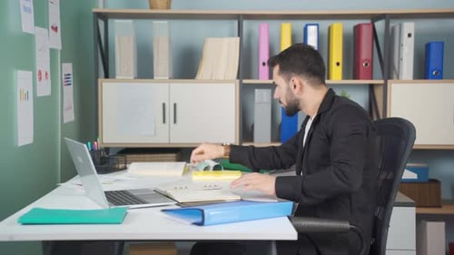 Young businessman working in his office.
