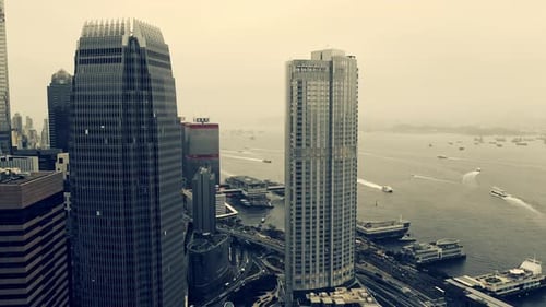 Sea, buildings and skyscraper in harbor with water, infrastructure or travel by boat in Hong Kong
