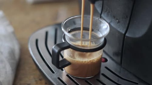 Cinematic Coffee: Close-Up Video of Coffee Machine Making a Fresh Cup of Coffee