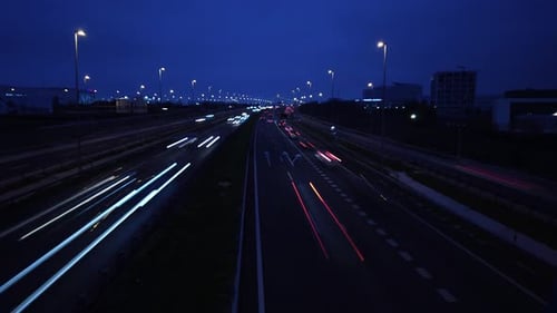 A motion lapse over the highway of traffic. Starts at night and end at dawn.
