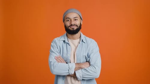 Young Man Gesturing Okay on Orange Background