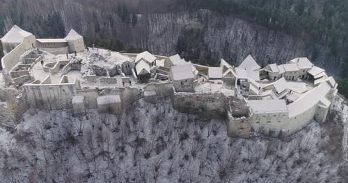 Aerial slide of Rasnov Citadel in Romania, during winter time.