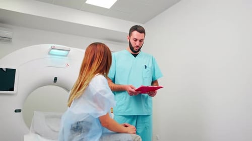 Doctor Discussing with Patient Near Medical Scanner