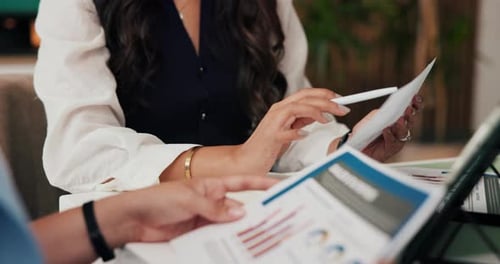 Business Meeting: Women Review Charts and Graphs