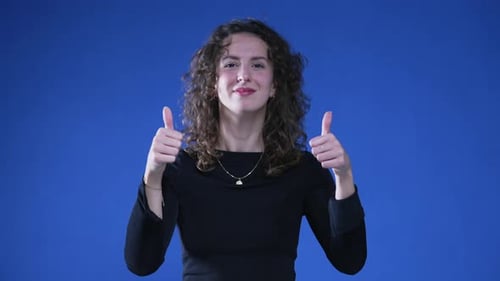 Smiling Woman Gives Thumbs Up and OK Sign