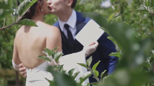 Bride and Groom Kissing After Vows in Garden