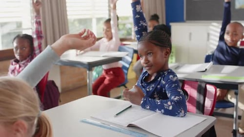 In school, students raising hands and participating in classroom discussion