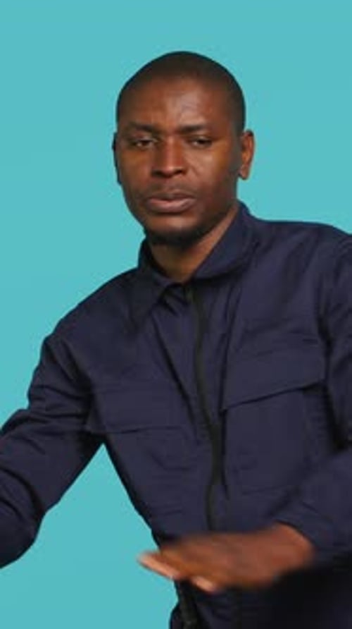 Man Pushing Against Invisible Barrier on Blue