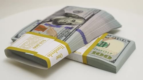 Stack of Bank Bundles with US Dollars on a White Background Closeup Shot of New Freshly Printed