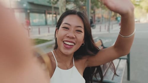 Smiling Woman Filming a Video in the City