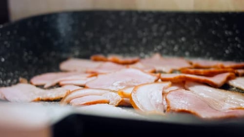 Bacon Cooking and Sizzling in a Pan