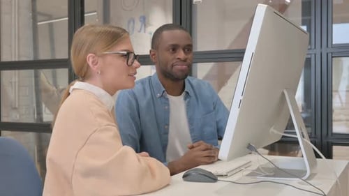 Team Collaborating on Computer in Modern Office