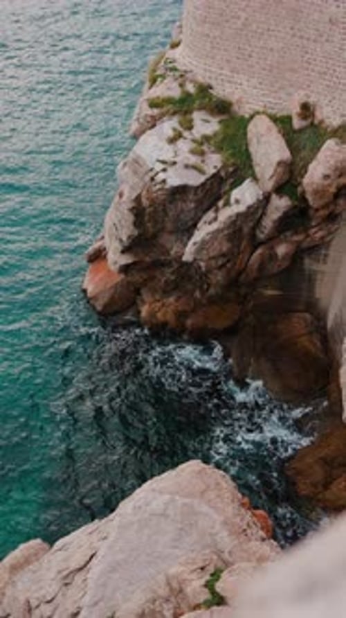 Smooth Turquoise Water of Mediterranean Sea with Rocks Vertical Shooting Top Amazing View of