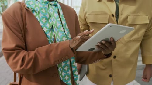 Adults Using Tablet Device in the City