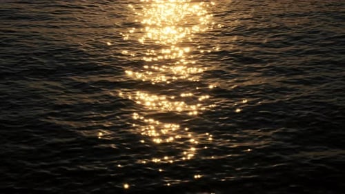 The sea's surface glittered with sparks.