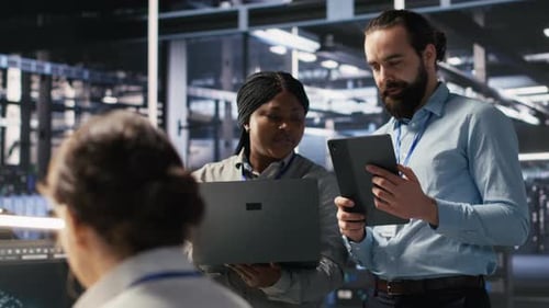 Workers Discuss Data in Server Room