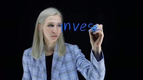 Woman Writes Investment On Glass Screen With Marker