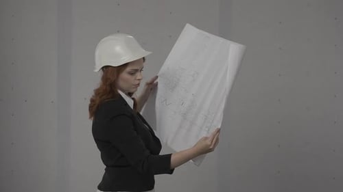 Side View of an Architect Woman Holding a Plan of a Building in Her Hands A Business Woman is