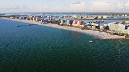 Beachfront skyline with pier and turquoise ocean waters — aerial perspective