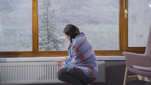 Young Asian woman cold in winter is hugging the combi.