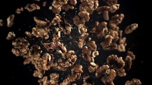 Shelled Walnuts Floating on a Black Background