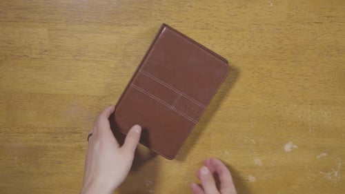 Guy putting bible down on table
