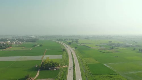 Amazing aerial view of the well-organized agricultural land divided by the express highway in Punjab