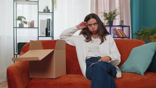 Woman Opens Box and Expresses Disappointment with Phone