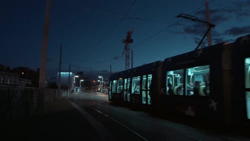 A blue tram moving into the city center at night, Montpellier - France