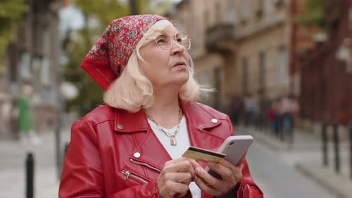 Senior Woman Using Credit Bank Card Smartphone While Transferring Money Purchases Online Shopping
