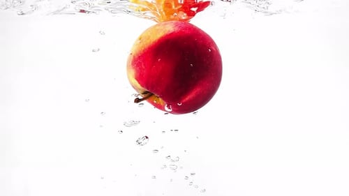 Vibrant Apple Sinking Through Clear Water
